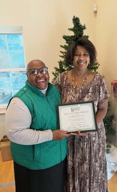 BBBS CEO Pat Daniel is pictured with Sander Wingate. Sander Wingate is holding her award for 15 years of service as a Board Secretary and Big Sister.