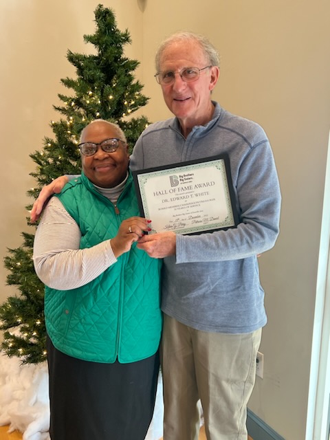 BBBS CEO Pat Daniel is pictured with Doctor Edward White. Doctor Edward White is holding his award for 30 years of service as a Board Member, Chairperson, and Treasurer.